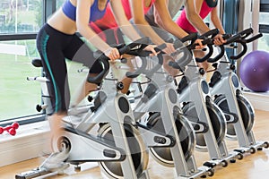 Mid section of people working out at spinning class photo