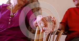 Mid section of senior couple holding hands at nursing home 4k