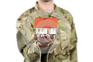 Mid section of soldier holding a model home