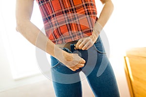 Mid section view of slim woman wearing blue stretch jeans