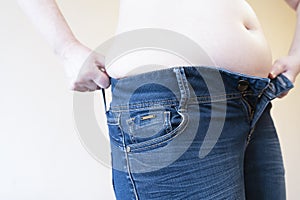 Mid section of woman with excessive belly. Overweight and over eating concept
