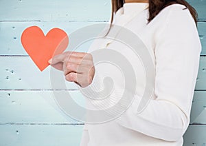 Mid-section of woman holding broken hearts