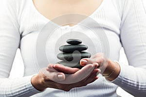 Mid section of woman holding pebbles