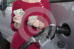 Mid Section Of A Woman Refueling Her Car photo