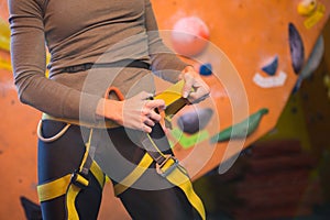 Mid section of woman wearing safety harness