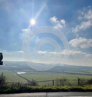 Midday sun shining over fields