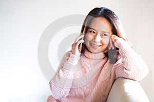 Middle adult Asian woman using smart phone. Hand holding phone a