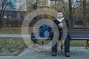 Middle adult calm bearded man sitting on bench lonely melancholy mood in autumn park dray ordinary day