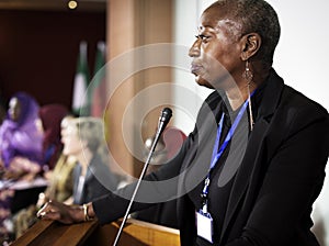 A Middle African Descent Woman Speaking into a Microphone