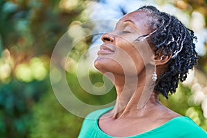 Middle age african american woman smiling confident breathing at park