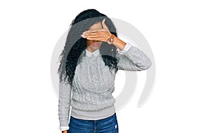 Middle age african american woman wearing casual clothes covering eyes with hand, looking serious and sad