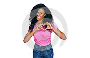 Middle age african american woman wearing casual clothes smiling in love showing heart symbol and shape with hands