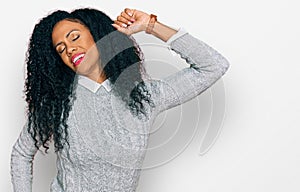 Middle age african american woman wearing casual clothes stretching back, tired and relaxed, sleepy and yawning for early morning