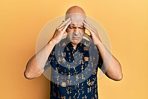 Middle age bald man wearing casual clothes suffering from headache desperate and stressed because pain and migraine