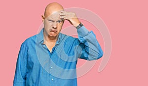 Middle age bald man wearing casual clothes worried and stressed about a problem with hand on forehead, nervous and anxious for