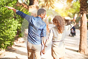 Middle age beautiful couple smiling happy and confident at town park