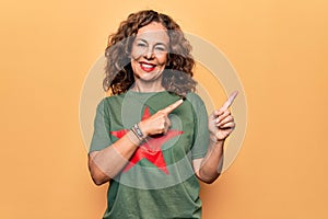 Middle age beautiful woman wearing t-shirt with red star revolutionary symbol of communism smiling and looking at the camera