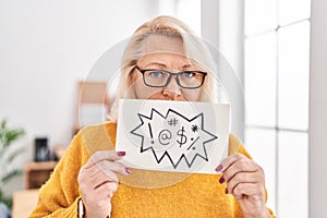 Middle age blonde woman business worker holding shooting message banner at office