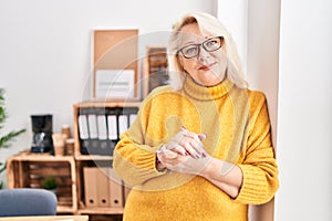 Middle age blonde woman business worker smiling confident standing at office