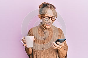 Middle age blonde woman using smartphone and drinking a cup of coffee celebrating crazy and amazed for success with open eyes