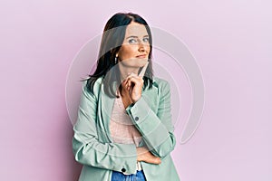 Middle age brunette woman wearing casual clothes with hand on chin thinking about question, pensive expression