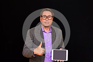 Middle age Business man holding and shows thumb up at pc with blank screen