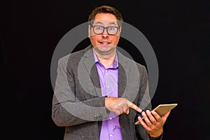 Middle age Business man holding and shows to tablet pc with blank screen