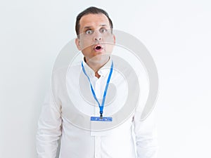 Middle age business man wearing ID card over white background afraid and shocked with surprise expression, fear and excited face