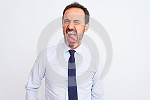 Middle age businessman wearing elegant tie standing over isolated white background sticking tongue out happy with funny expression