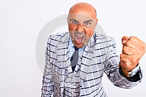 Middle age businessman wearing suit standing over isolated white background angry and mad raising fist frustrated and furious