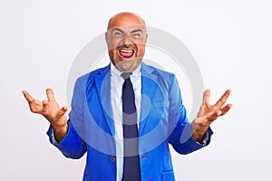 Middle age businessman wearing suit standing over isolated white background celebrating crazy and amazed for success with arms