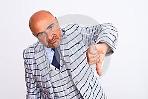 Middle age businessman wearing suit standing over isolated white background looking unhappy and angry showing rejection and