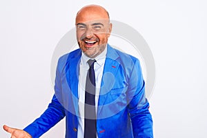 Middle age businessman wearing suit standing over isolated white background smiling cheerful with open arms as friendly welcome,