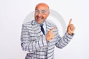 Middle age businessman wearing suit standing over isolated white background smiling and looking at the camera pointing with two