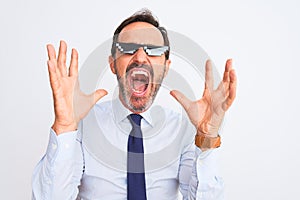 Middle age businessman wearing thug life sunglasses over isolated white background celebrating mad and crazy for success with arms