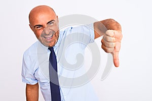 Middle age businessman wearing tie standing over isolated white background looking unhappy and angry showing rejection and