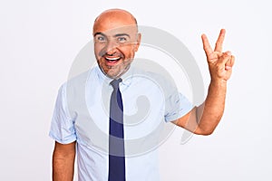 Middle age businessman wearing tie standing over isolated white background showing and pointing up with fingers number two while