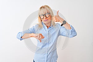 Middle age businesswoman wearing elegant shirt and glasses over isolated white background Doing thumbs up and down, disagreement