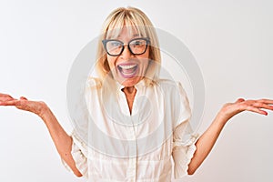 Middle age businesswoman wearing shirt and glasses standing over isolated white background very happy and excited, winner