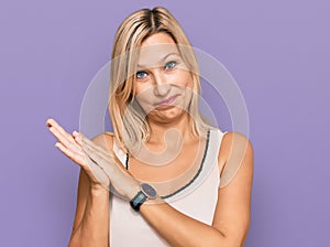 Middle age caucasian woman wearing casual clothes clapping and applauding happy and joyful, smiling proud hands together