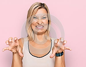 Middle age caucasian woman wearing casual clothes smiling funny doing claw gesture as cat, aggressive and sexy expression