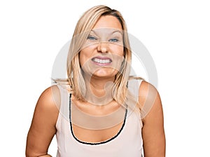 Middle age caucasian woman wearing casual clothes smiling and laughing hard out loud because funny crazy joke with hands on body