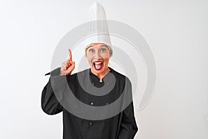 Middle age chef woman wearing uniform and hat standing over isolated white background pointing finger up with successful idea