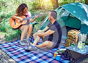 Middle age couple  of hiker smiling happy camping at the forest