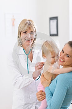 Middle age doctor examine baby using stethoscope