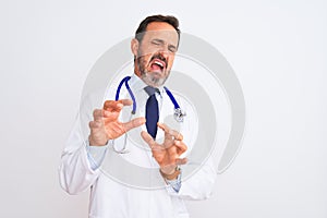 Middle age doctor man wearing coat and stethoscope standing over isolated white background disgusted expression, displeased and