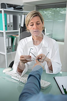 middle age female doctor talking to patient photo