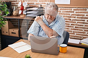 Middle age grey-haired man business worker suffering for backache at office