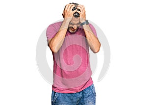 Middle age grey-haired man wearing casual clothes suffering from headache desperate and stressed because pain and migraine