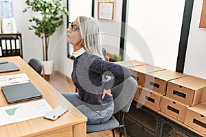 Middle age grey-haired woman business worker suffering for backache at office